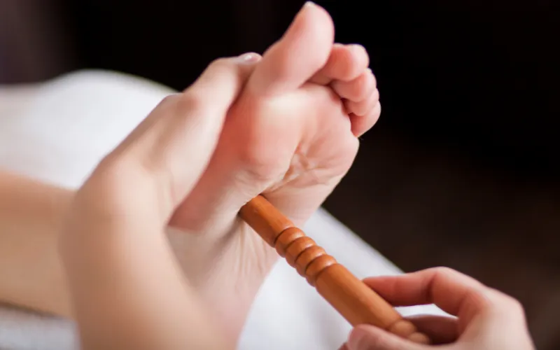 Therapist performing foot reflexology pressure technique in Chennai spa
